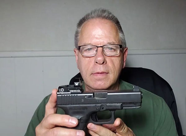 GLOCK 23 pistol with Vortex red dot sight, and tall front sight.